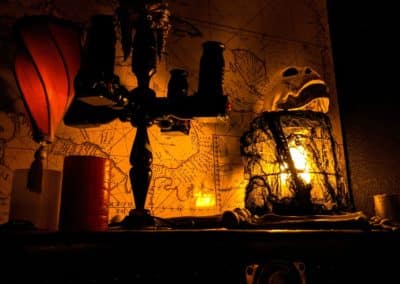A candle in front of a creepy old map.